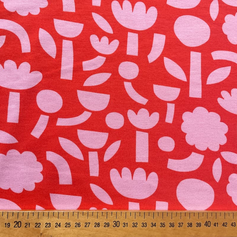 Tissu jersey gots fleurs rose fond orange